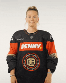 a woman is wearing a jersey that says penny on it