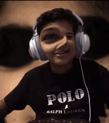 a boy wearing headphones and a black polo shirt