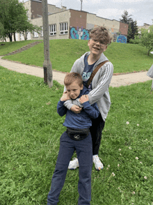 a boy wearing a blue shirt that says rf on it