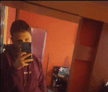 a man taking a picture of himself in front of a mirror with a hoodie that says freedom