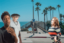 a man and a woman are standing in front of a no parking sign