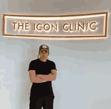 a man stands in front of the icon clinic sign