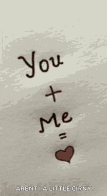 a sign that says " you + me " with a heart