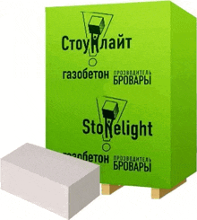 a green box with the word stonelight on it is sitting on a wooden pallet next to a white block .