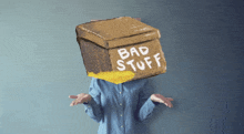 a woman has a cardboard box on her head that says bad stuff