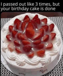 a birthday cake with whipped cream and strawberries on it