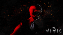 a poster for the mimic with a red monster