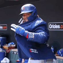 a baseball player wearing a blue jacket with the word barrio on the back