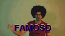 a man with an afro and glasses is dancing in front of the words famoso