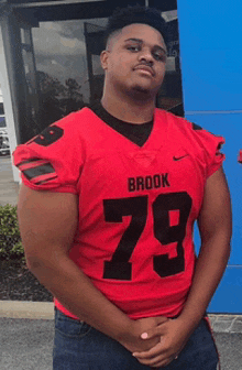 a man wearing a red jersey that says brook on it