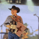 a man in a cowboy hat is holding an accordion that says " intricable " on it