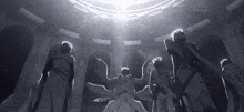 a group of angels are standing in a dark room with a light shining through the ceiling