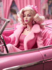 a barbie doll in a pink car with a pink bow in her hair