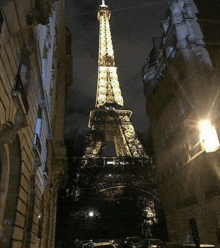 the eiffel tower is lit up at night in a city