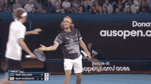 two tennis players on a court with an ad for ausopen.com/aces behind them