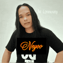 a man with long hair is wearing a black shirt that says jne community