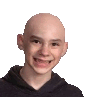 a young boy with a bald head is smiling