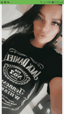 a woman is wearing a black jack daniels shirt