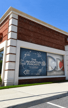 a brick building with a large window that says the inventive podcasts