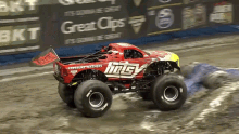 a red monster truck that says hots on the side