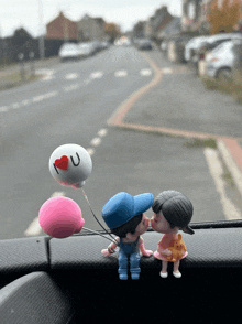 a boy and a girl kissing with a balloon that says " i love you "