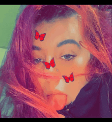 a girl with red hair has butterflies on her face