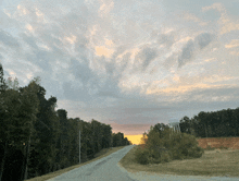 a road with a water tower in the distance