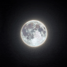 a full moon in a dark sky with a glowing edge