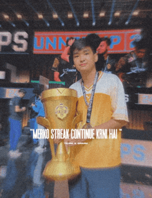 a boy holding a trophy with the words merko streak continue krni hai