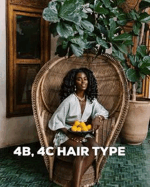 a woman is sitting in a chair holding a bowl of lemons .