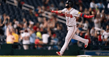 a baseball player is running towards a base during a game .