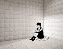 a person is sitting on the floor in a room with white tiles .