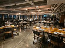 a large dining room with tables and chairs set for a meal