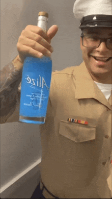 a man in a military uniform holds up a bottle of osilla