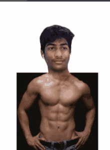 a shirtless young man with his hands on his hips looks at the camera