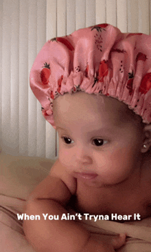 a baby wearing a pink shower cap with strawberries on it and the caption when you ain 't tryna hear it