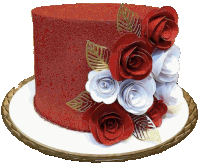 a cake with red and white roses and gold leaves