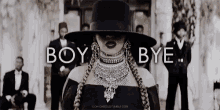 a woman in a black hat stands in front of a group of men with the words boy bye written above her