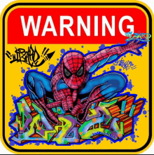 a warning sign with graffiti on it and a picture of spider man