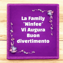 a purple sign with the words la family " ninfee " vi augura buon divertimento