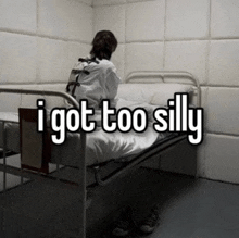 a person in a straight jacket is sitting on a bed with the words " i got too silly " on the bottom