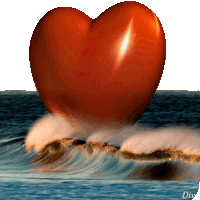 a large red heart is floating on top of the ocean waves