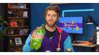 a man is holding a bottle of mountain dew in front of a screen that says shortcircuit