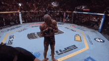 a man stands in a boxing ring with espn written on the floor