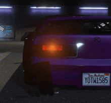 a purple car with a license plate that says yotw1586