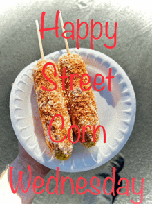 two corn on the cob on a paper plate that says happy street corn