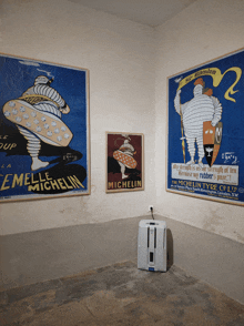 three framed michelin posters hang on a wall in a room