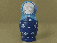 a blue green and orange matryoshka doll with white flowers on it