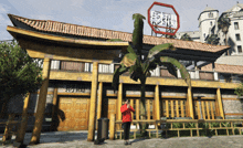 a man in a red jacket stands in front of a building that has chinese writing on it