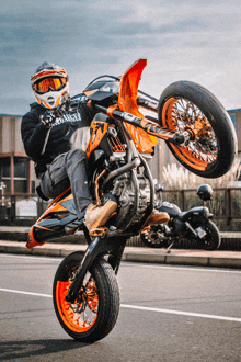 a man is doing a trick on a dirt bike with a hoodie that says ' samurai ' on the front